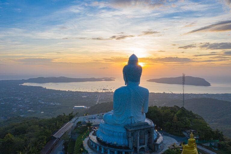 The Big Buddha statue on top of mountain-facing to ocean, islands, sunrise sky