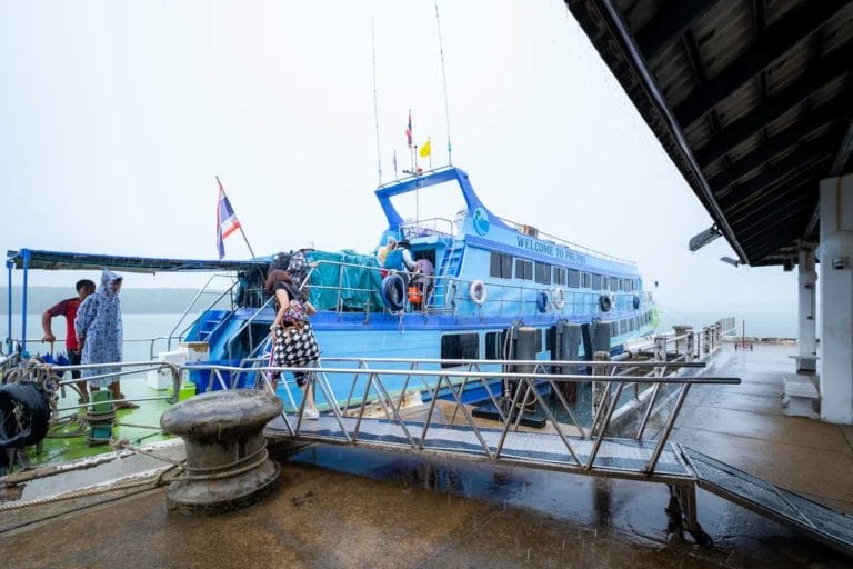 Big Blue ship with Thailand flags at pier