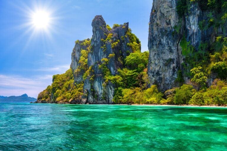 Koh Yung-cliff island with yellow green plants surrounded by dark green ocean in a sunny day